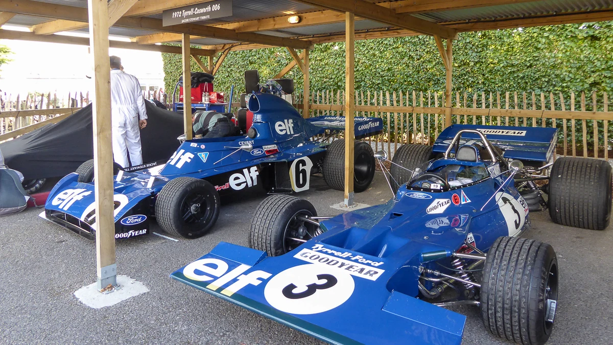 Historic motorsport enthusiasts wearing vintage style paddock jackets