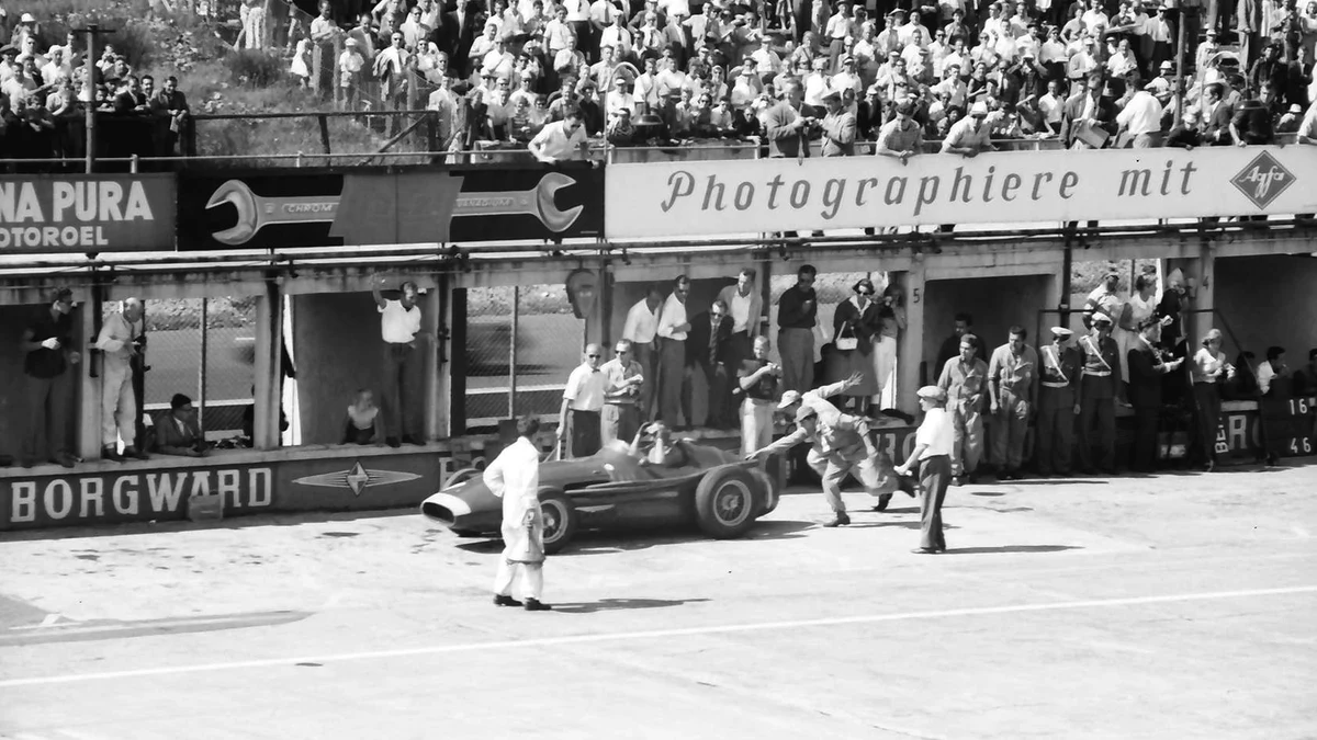 Mid-century Grand Prix mechanics wearing heavy cotton workshop coats