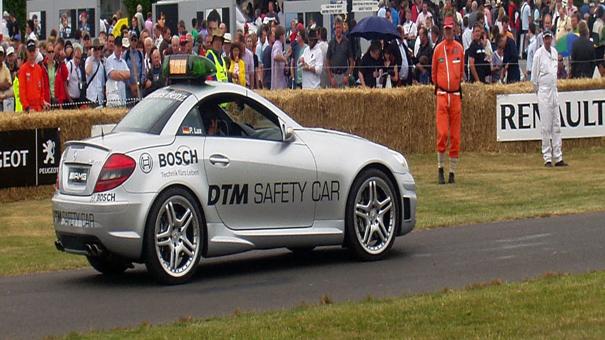 Safety Car Leading Field During Full Course Yellow Flag Official safety car deployed during a full course yellow flag period