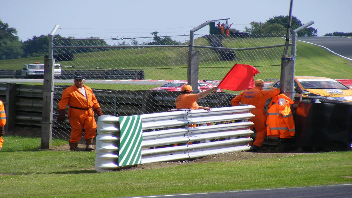 Trackside Marshals Operating Safety Warning Flags Trackside flag marshals station signaling yellow flag hazard conditions